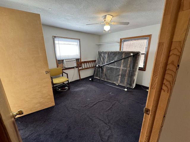 unfurnished bedroom with a ceiling fan, cooling unit, dark carpet, and a textured ceiling