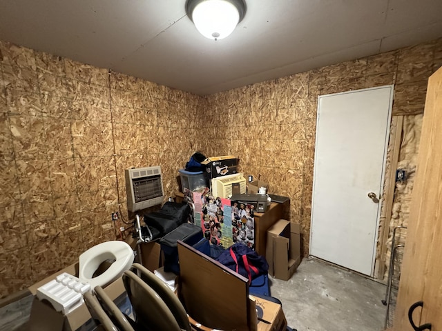 misc room featuring heating unit and concrete flooring