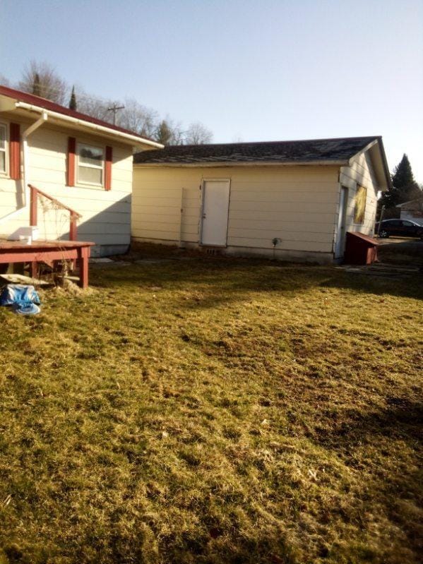 rear view of property with a yard