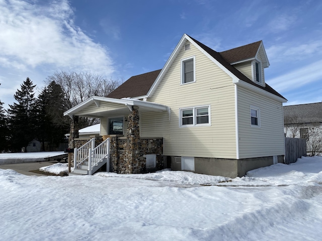 view of snow covered rear of property