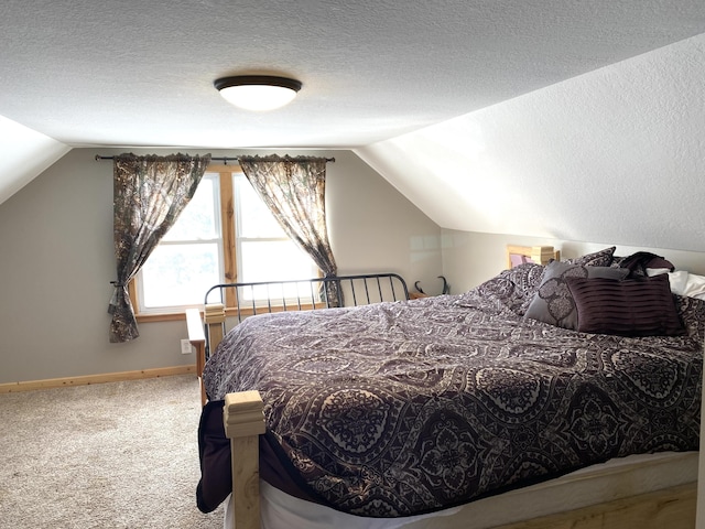 bedroom featuring carpet floors, vaulted ceiling, a textured ceiling, and baseboards