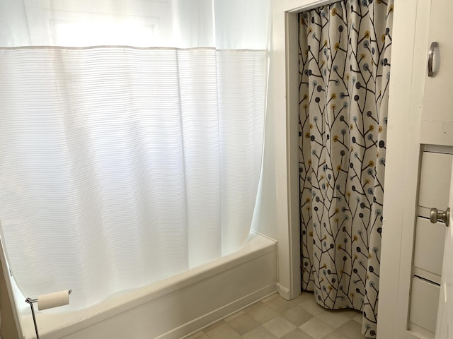 bathroom with shower / bath combination with curtain