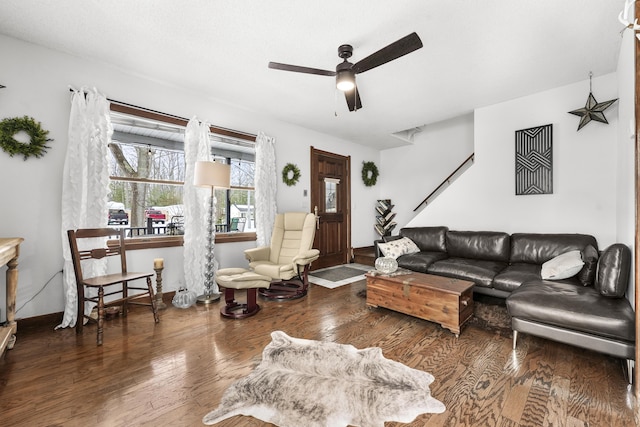 living area with ceiling fan, baseboards, and wood finished floors