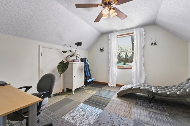 office with lofted ceiling, ceiling fan, a textured ceiling, and baseboards