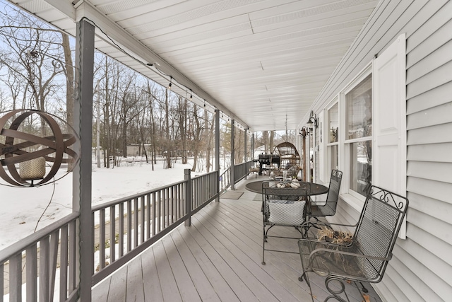 snow covered deck with covered porch