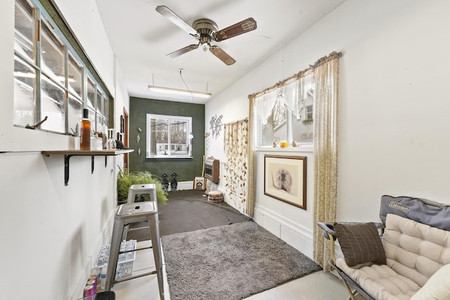 interior space featuring concrete floors, heating unit, and ceiling fan