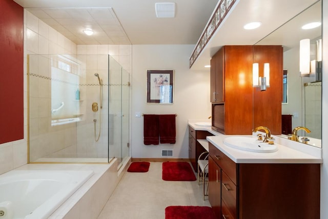 bathroom featuring two vanities, a sink, visible vents, a bath, and a stall shower