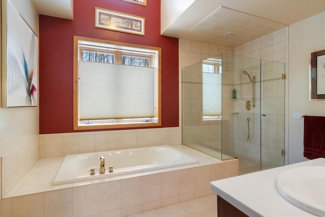 bathroom with vanity, a shower stall, and a bath