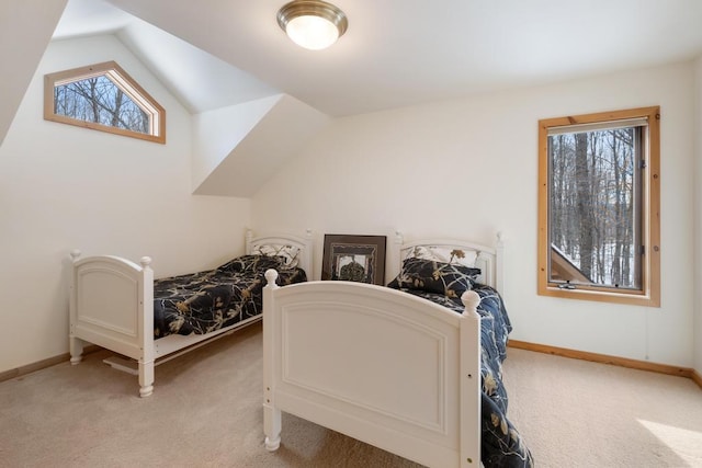 bedroom featuring vaulted ceiling, baseboards, and light colored carpet