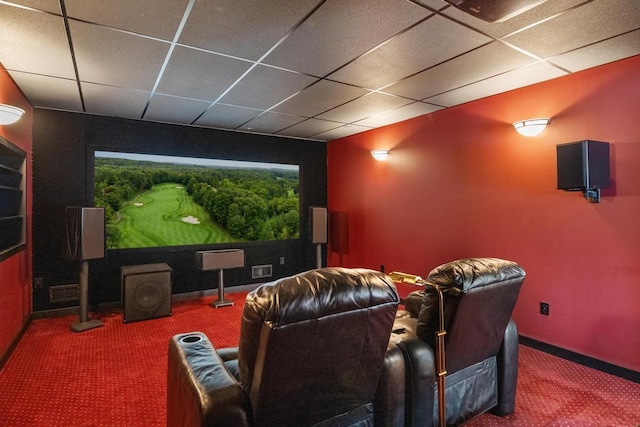 home theater with a drop ceiling, carpet, and baseboards