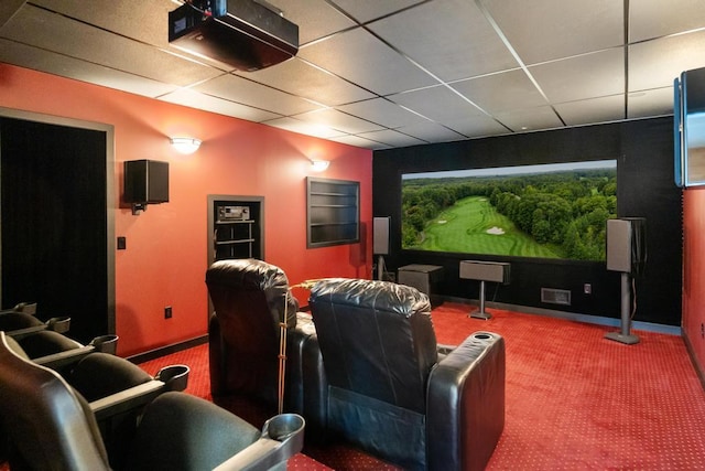 home theater with carpet, visible vents, a paneled ceiling, and baseboards