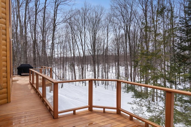 snow covered deck featuring a grill