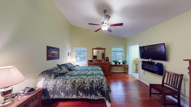 bedroom with dark wood-style floors, lofted ceiling, ceiling fan, and baseboards