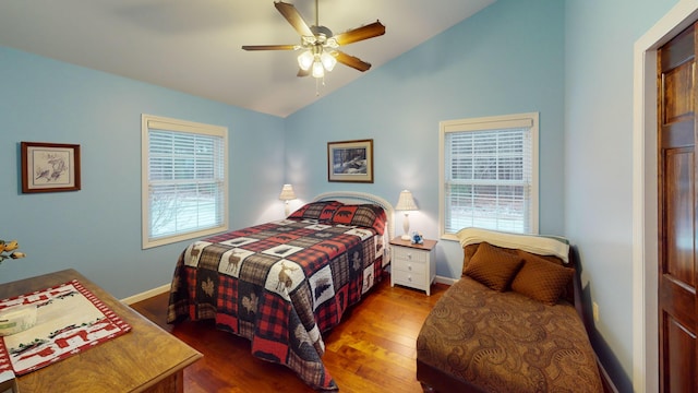 bedroom with lofted ceiling, wood finished floors, a ceiling fan, and baseboards