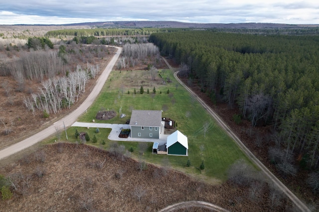 aerial view featuring a view of trees and a rural view