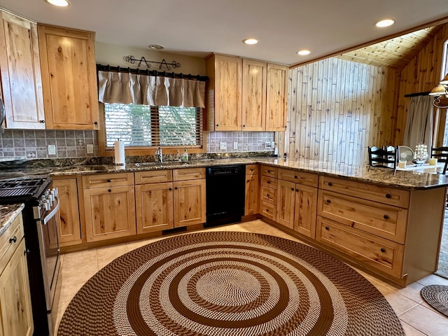 kitchen featuring black dishwasher, tasteful backsplash, stainless steel range with gas stovetop, a peninsula, and a sink