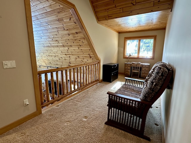 sitting room featuring carpet, wooden ceiling, and baseboards