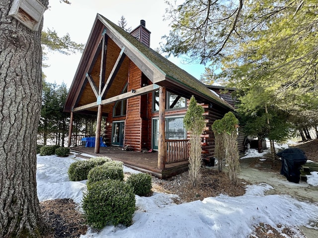 exterior space with a chimney and log exterior