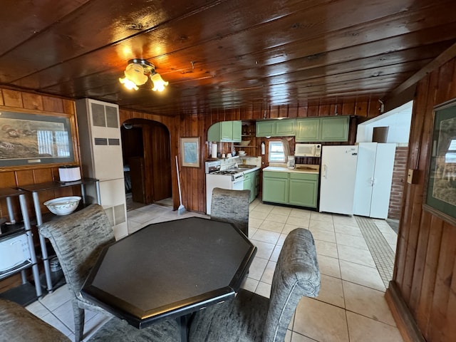 dining area with arched walkways, wood ceiling, light tile patterned flooring, and wood walls