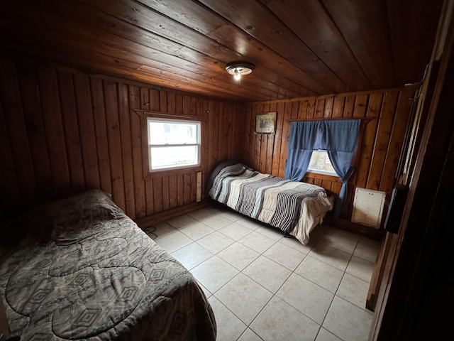 bedroom with wood ceiling, wooden walls, and light tile patterned floors