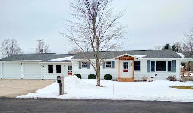 ranch-style house featuring a garage, entry steps, and driveway