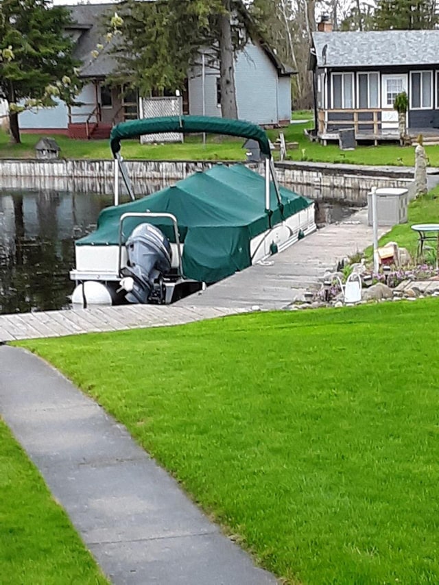 view of dock featuring a yard and a water view