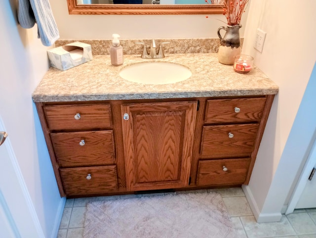 bathroom featuring baseboards, vanity, and tile patterned floors