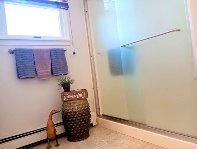 bathroom with a stall shower, tile patterned flooring, and a baseboard radiator