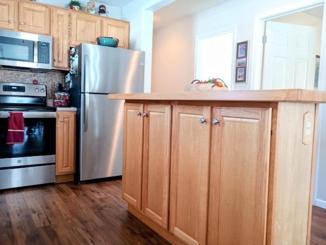 kitchen with light brown cabinets, stainless steel appliances, light countertops, tasteful backsplash, and dark wood finished floors