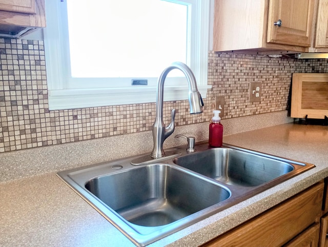 details with light countertops, tasteful backsplash, and a sink