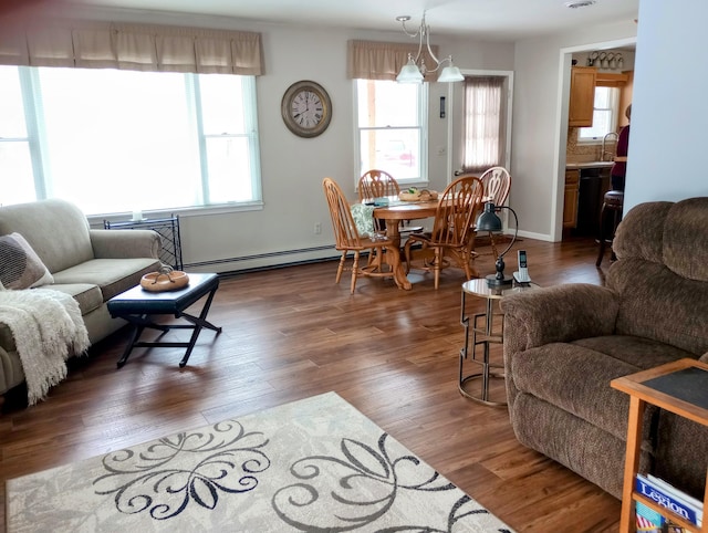 living room with a baseboard radiator, visible vents, and wood finished floors