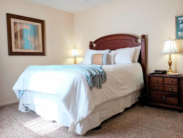 carpeted bedroom featuring baseboards