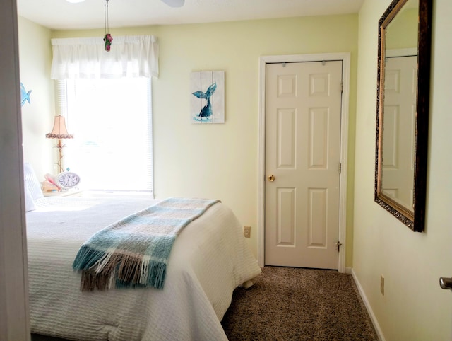 carpeted bedroom featuring baseboards