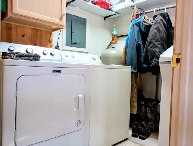 laundry area featuring cabinet space, electric panel, and washer and clothes dryer