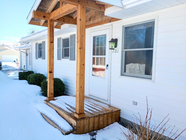 view of snow covered property entrance