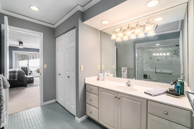 full bath featuring a stall shower, baseboards, tile patterned flooring, crown molding, and vanity