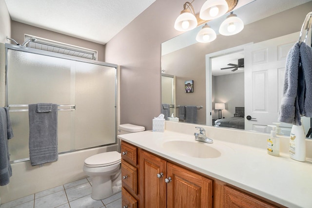 full bathroom with shower / bath combination with glass door, toilet, vanity, ensuite bath, and tile patterned flooring