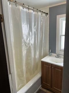 bathroom featuring shower / bathtub combination with curtain and vanity