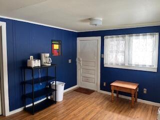 foyer with wood finished floors and baseboards