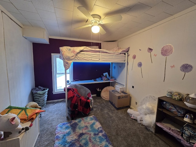 bedroom featuring a ceiling fan, crown molding, and carpet