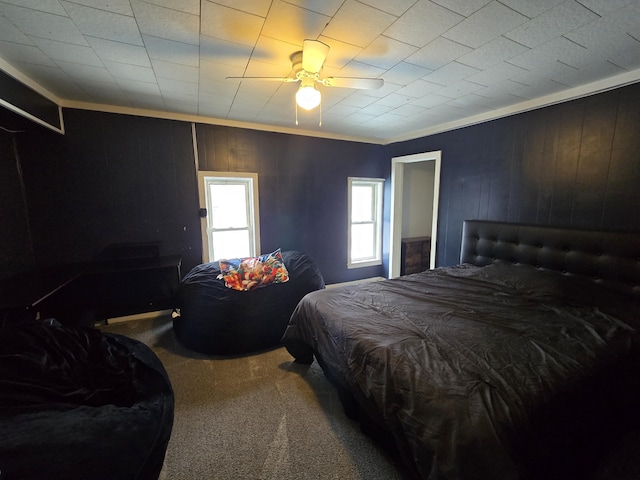 carpeted bedroom featuring a ceiling fan and ornamental molding