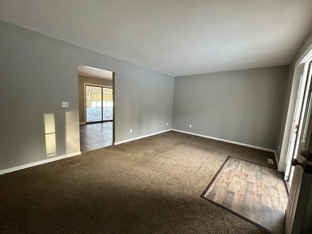 unfurnished room featuring baseboards and carpet flooring