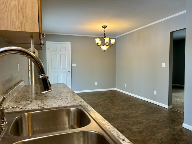 kitchen with a notable chandelier, baseboards, crown molding, and decorative light fixtures