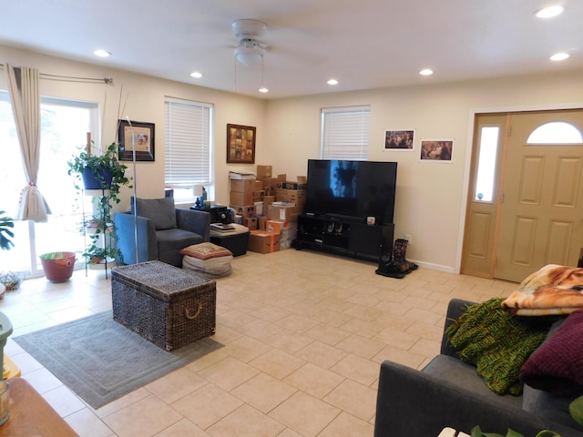 living room featuring light tile patterned floors, ceiling fan, baseboards, and recessed lighting