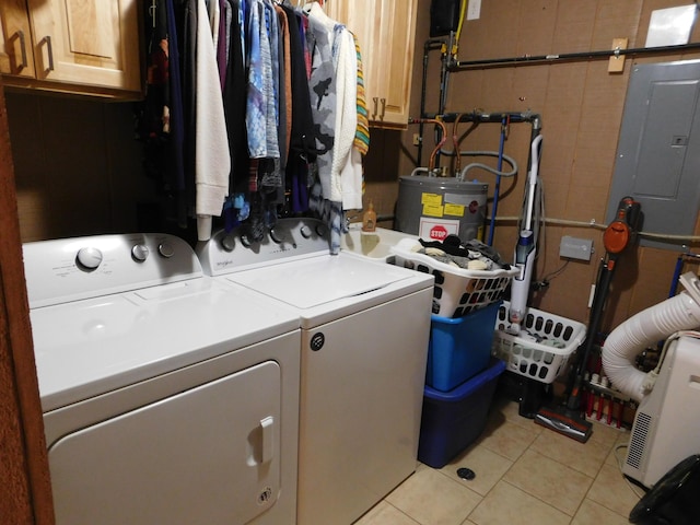 laundry area with cabinet space, light tile patterned flooring, electric water heater, washer and dryer, and electric panel