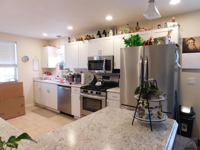 kitchen with hanging light fixtures, white cabinetry, appliances with stainless steel finishes, and recessed lighting