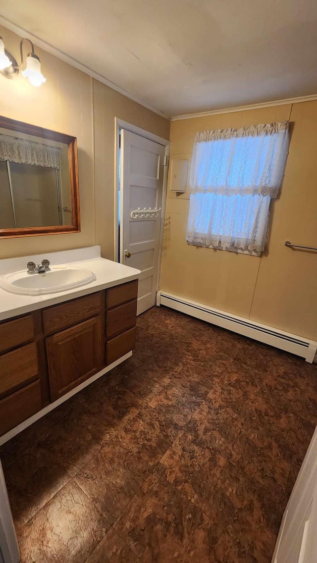 bathroom with a baseboard radiator, crown molding, and vanity