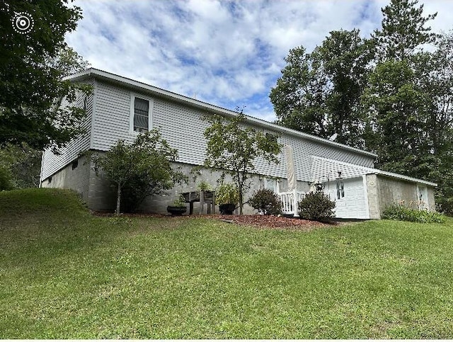 view of property exterior featuring a garage and a yard