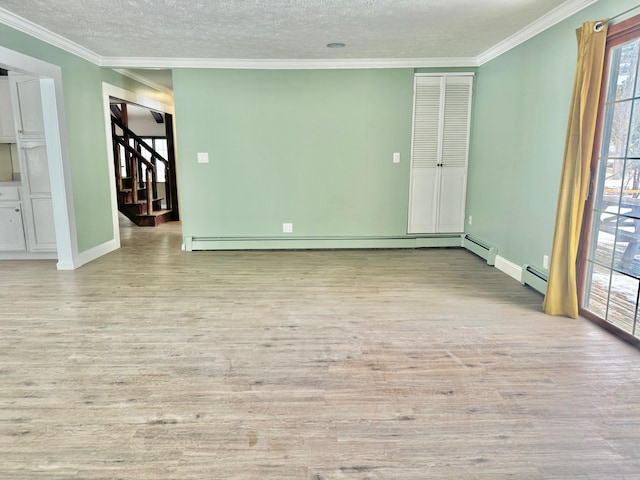 empty room with ornamental molding and wood finished floors