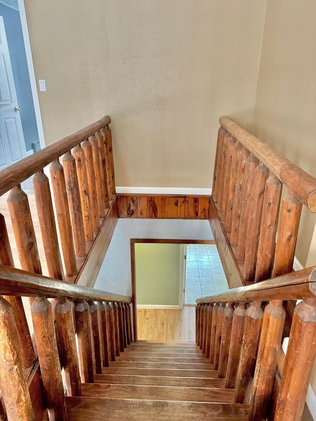 staircase featuring wood finished floors